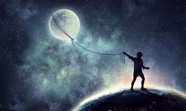 Silhouette of a child standing on the globe, pulling the moon on a rope